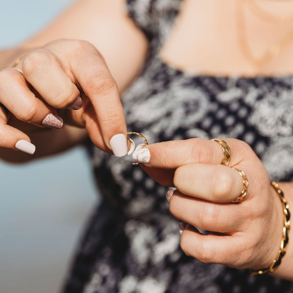 Adjustable ring being resized for larger or smaller fingers.