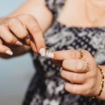 Adjustable ring being resized for larger or smaller fingers.