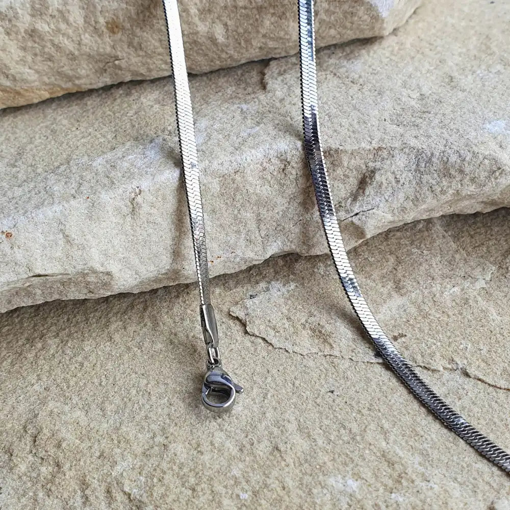 Sleek Snake Chain necklace and bracelet bundle in silver with a stunning herringbone design. Available in 45cm+5cm and 60cm+5cm lengths. Waterproof, hypoallergenic, and tarnish-resistant.