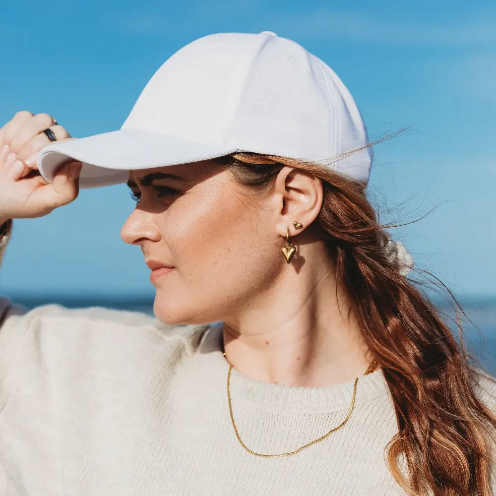Woman in New Zealand wearing the Delicate Twist Necklace in 18k gold plating, showcasing a subtle twisted chain design with a refined, everyday elegance.