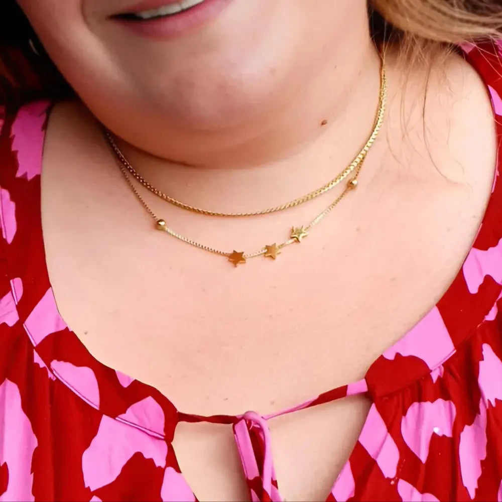Gold plated necklace with star charms on plus size woman
