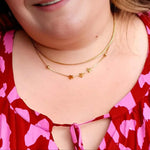 Gold plated necklace with star charms on plus size woman