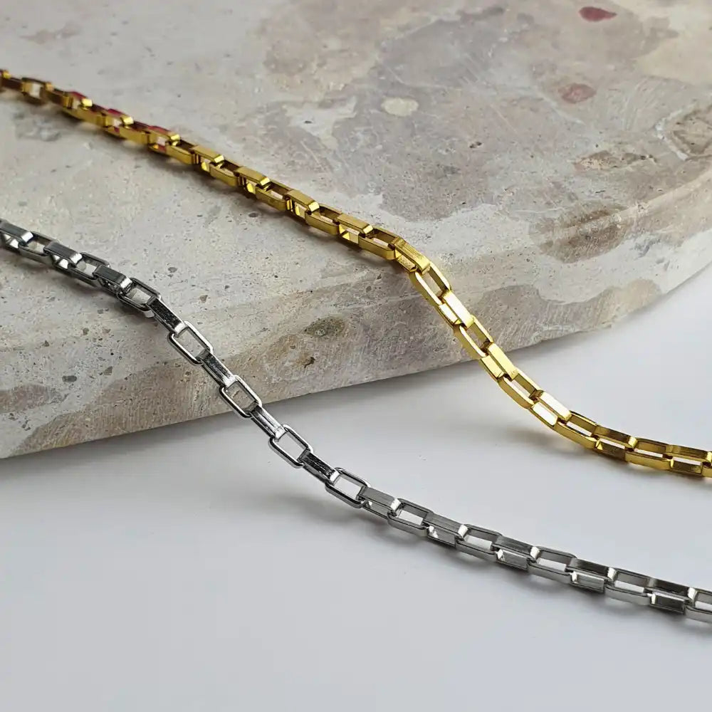 Two Bold Links Chain Necklaces - one gold, one silver - hanging against a clean white background, showcasing their sleek, bold links and longer lengths (45cm + 5cm and 60cm + 5cm). Perfect for everyday layering or solo styling.