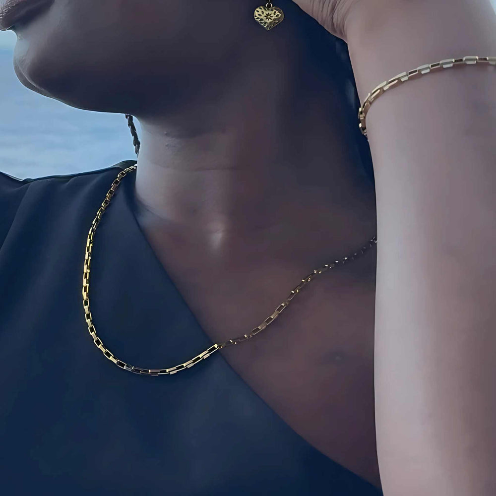 Woman wearing a gold-plated bold chain necklace with oversized links, adjustable length in 45cm or 60cm, also available in silver