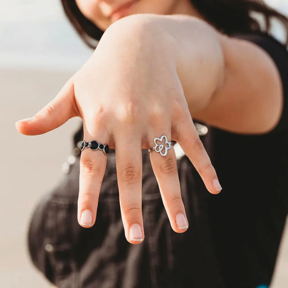 Flower power and bubbles adjustable rings both in silver. Waterproof, hypoallergenic and tarnish free ring stack.