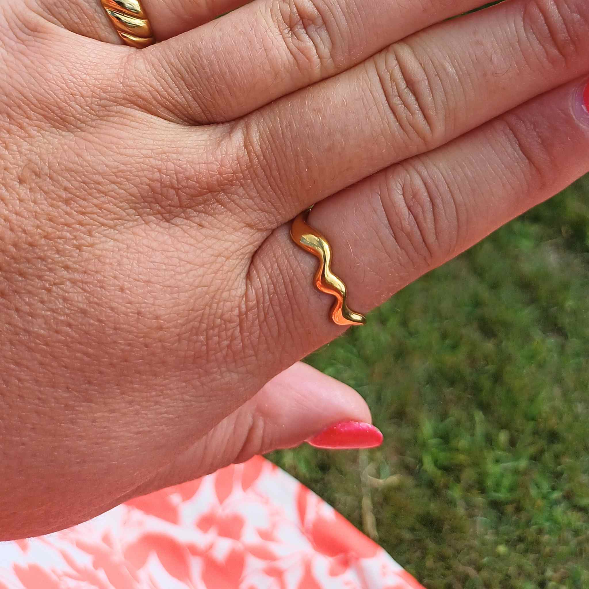 Plus-sized woman wearing Elegant Waves adjustable ring in gold with sleek, wavy design, adjustable fit, also comes in silver
