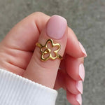 Woman wearing the Flower Power adjustable ring in 18K gold plating with elegant floral detail, also comes in silver