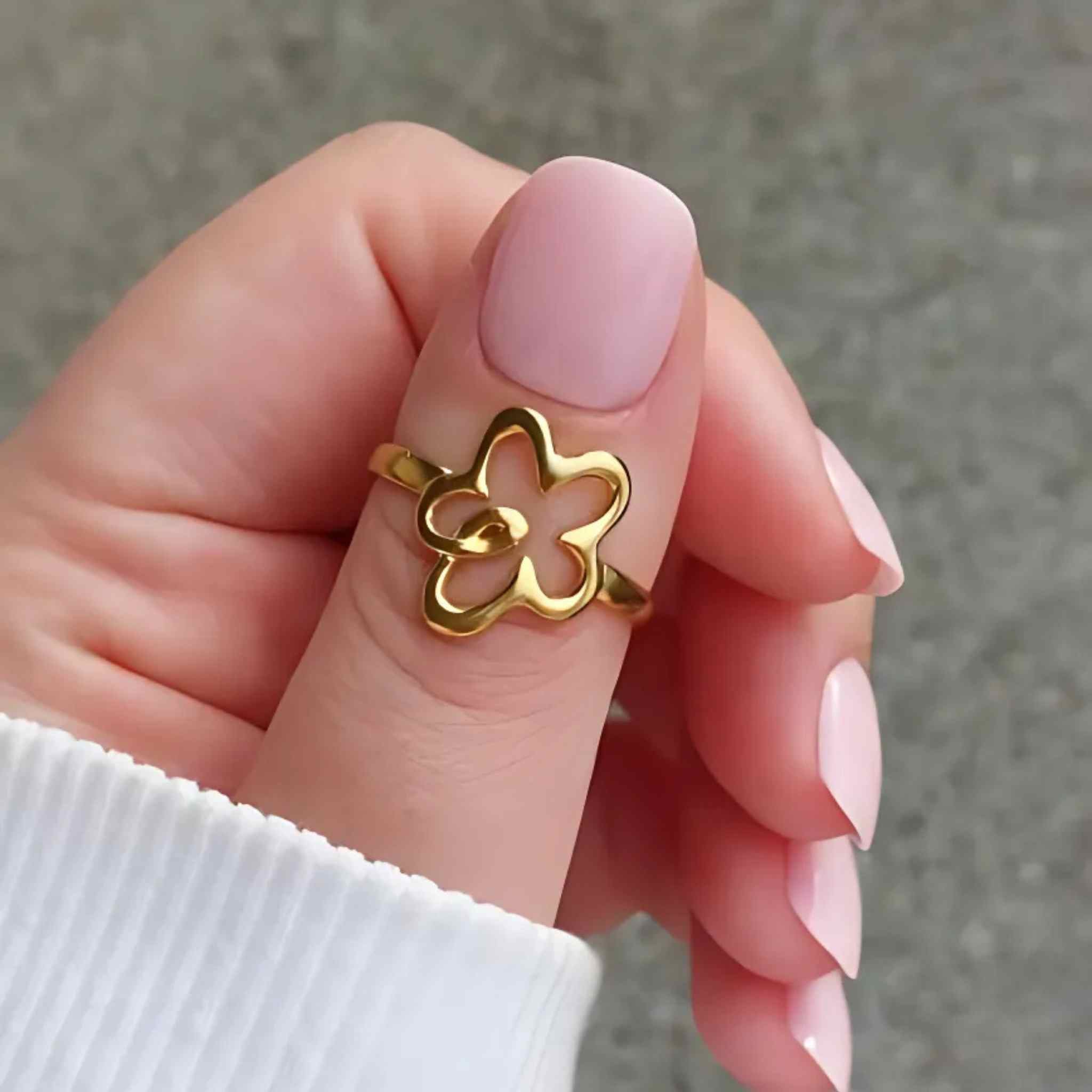 Woman wearing the Flower Power adjustable ring in 18K gold plating with elegant floral detail, also comes in silver