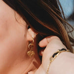 Plus-size woman wearing Glimmer Hoop Earrings in gold-plated stainless steel with polished finish and minimalist shine