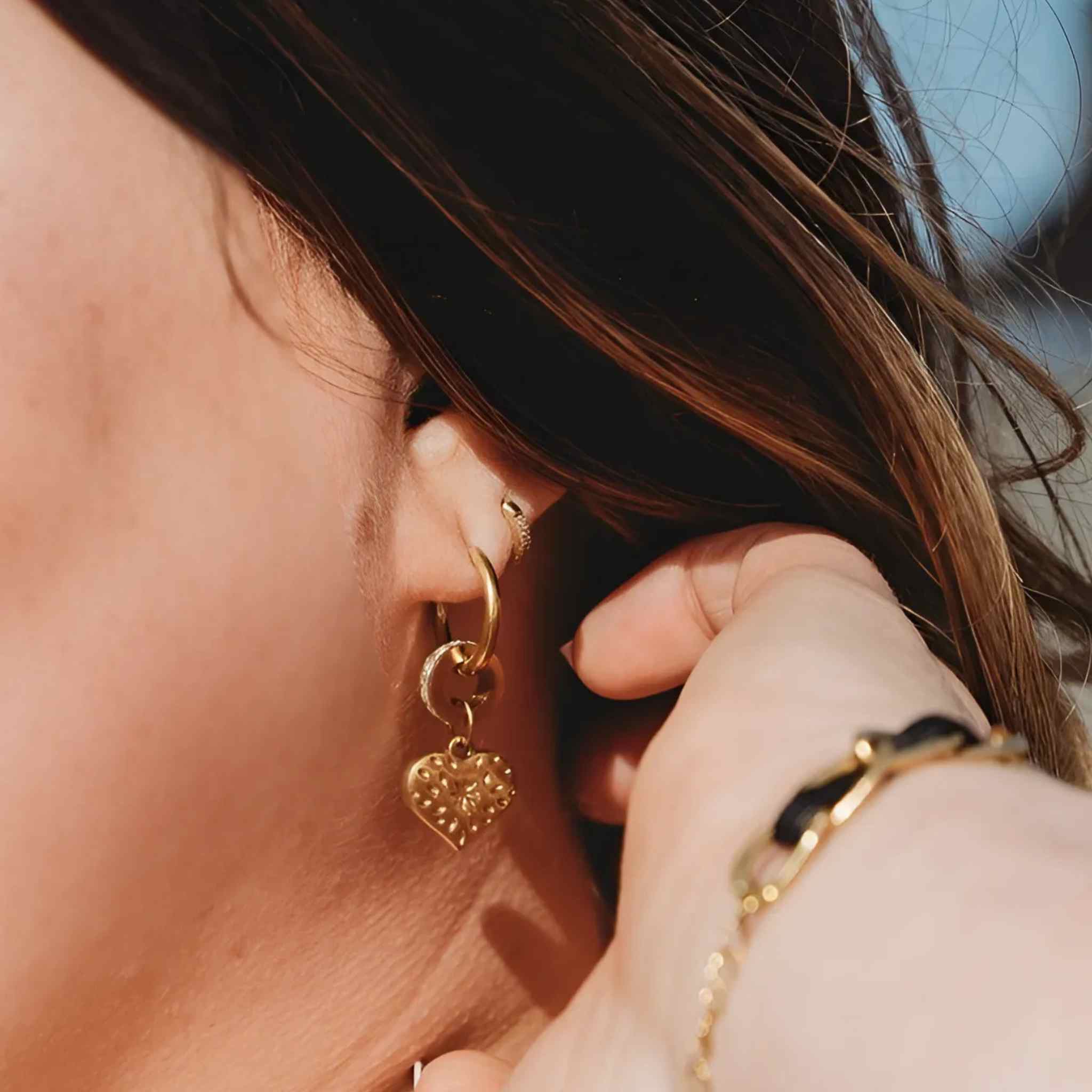Plus-size woman wearing Glimmer Hoop Earrings in gold-plated stainless steel with polished finish and minimalist shine