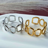 Harmonic shapes adjustable ring in 18k gold plated and silver on a stainless steel base. 