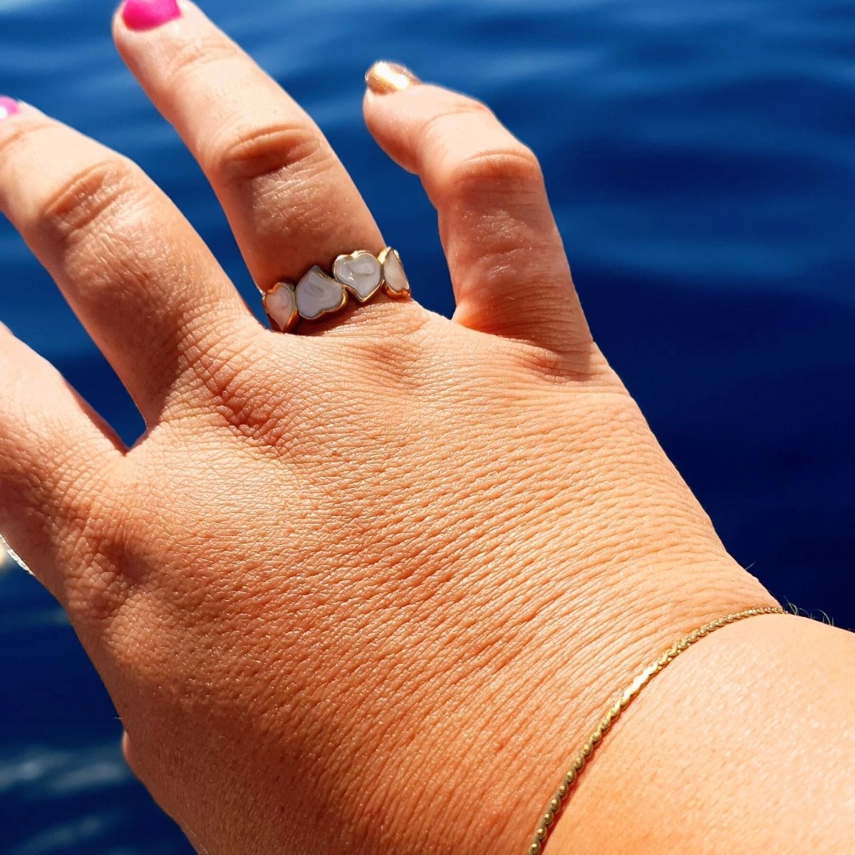 Eternal hearts adjustable ring in gold and white on a plus size hand. 