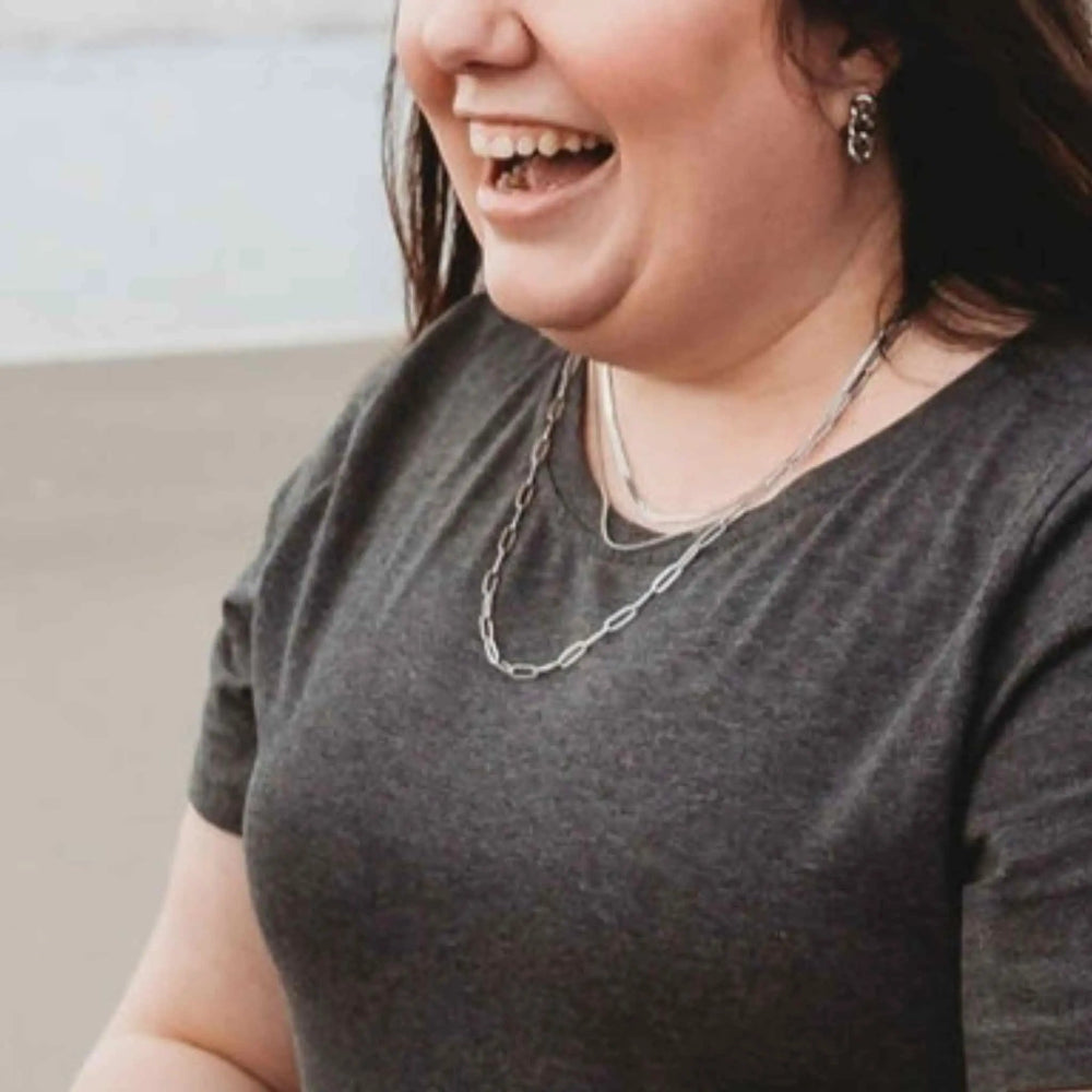 Smiling girl wearing the 45cm Silver Linked Up Paperclip Chain Necklace, featuring elongated links in a sleek, modern design.