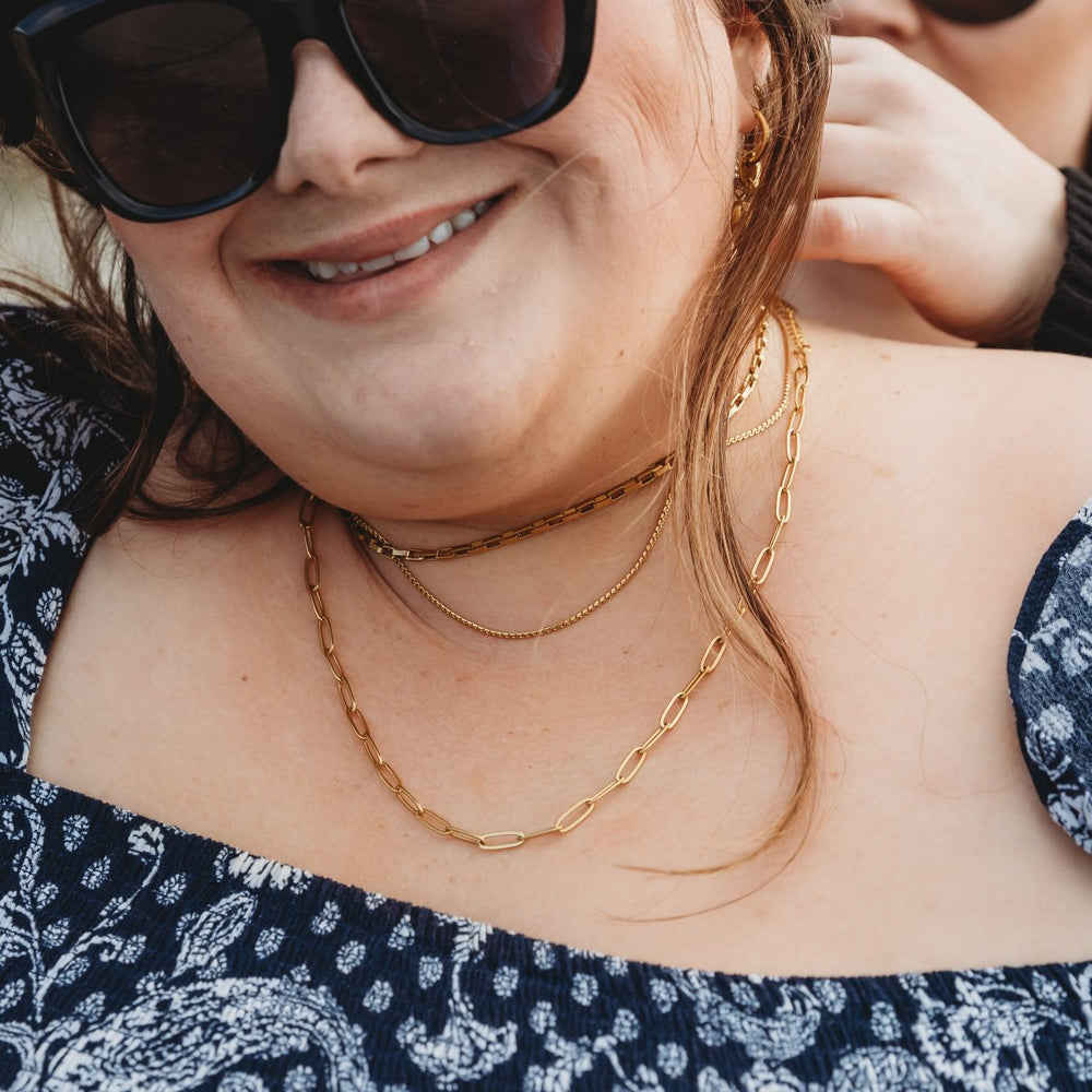 Kathryn helping her friend put on the 18k gold plated linked up paperclip chain necklace. Great for stacking or on it's own.
