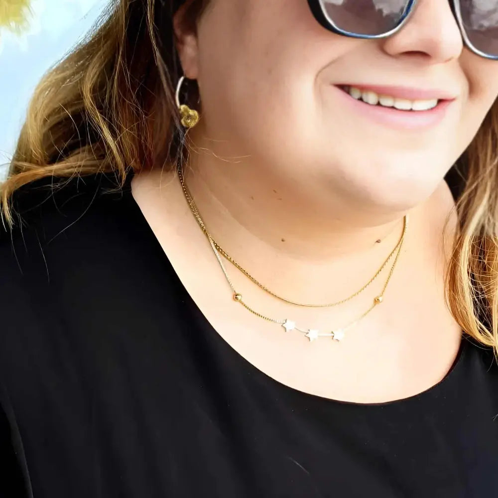 18k gold-plated layered necklace with star charms on plus size woman. 