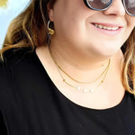 18k gold-plated layered necklace with star charms on plus size woman. 