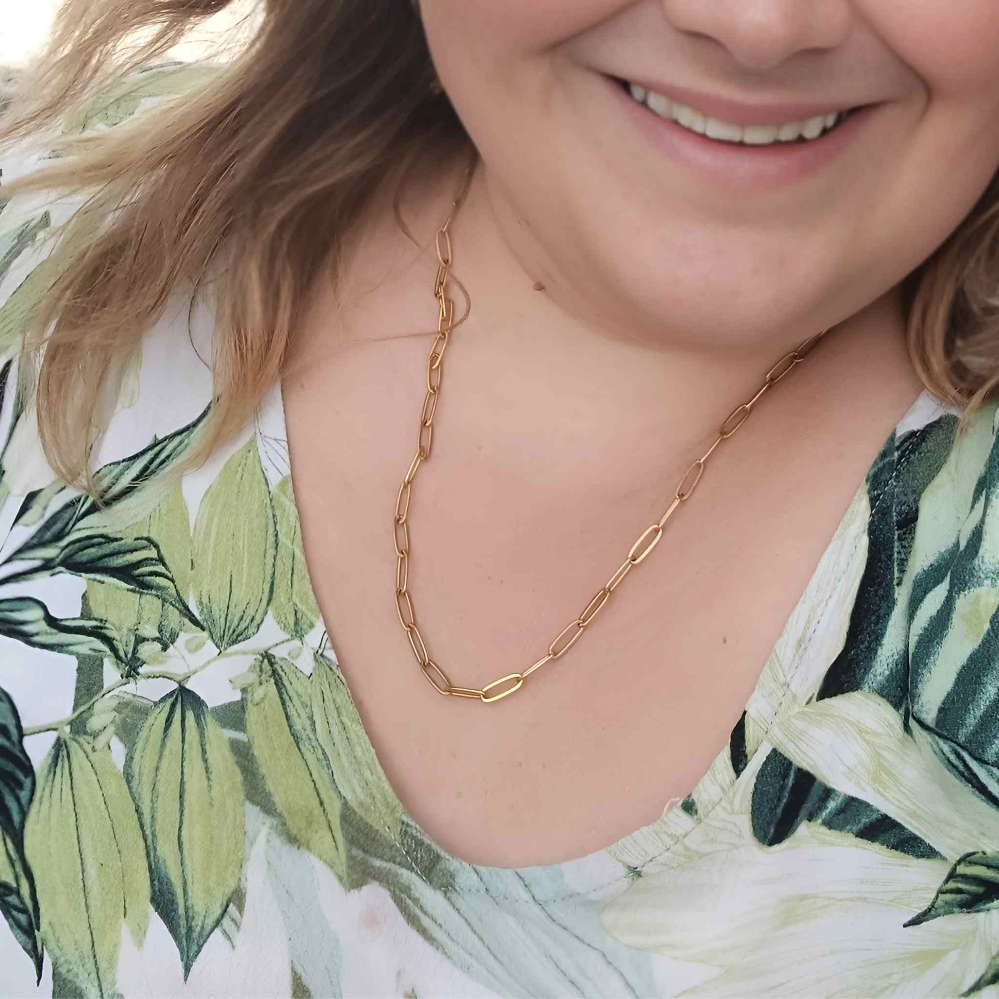 Plus-size woman wearing an adjustable gold-plated stainless steel paperclip chain necklace, available in 45cm and 60cm lengths, also offered in silve