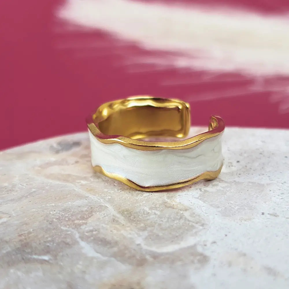 Bold, beautiful, and in gold and whitedesign.  This size 7 gold open ring is waterproof, hypoallergenic, and tarnish free.