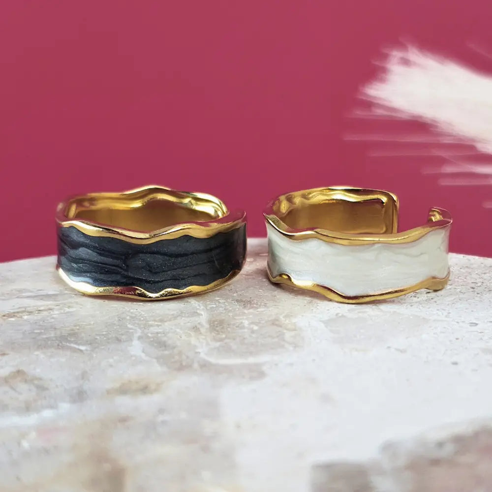 Bold, beautiful, and made to stand out. This size 7 gold open ring with white or black detailing is waterproof, hypoallergenic, and totally confidence-boosting.