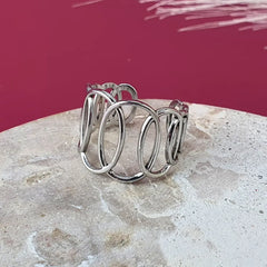 Adjustable twisted oval adjustable ring in stainless steel, fits sizes 5 to 16 comfortably. Resizeable and size-inclusive. 