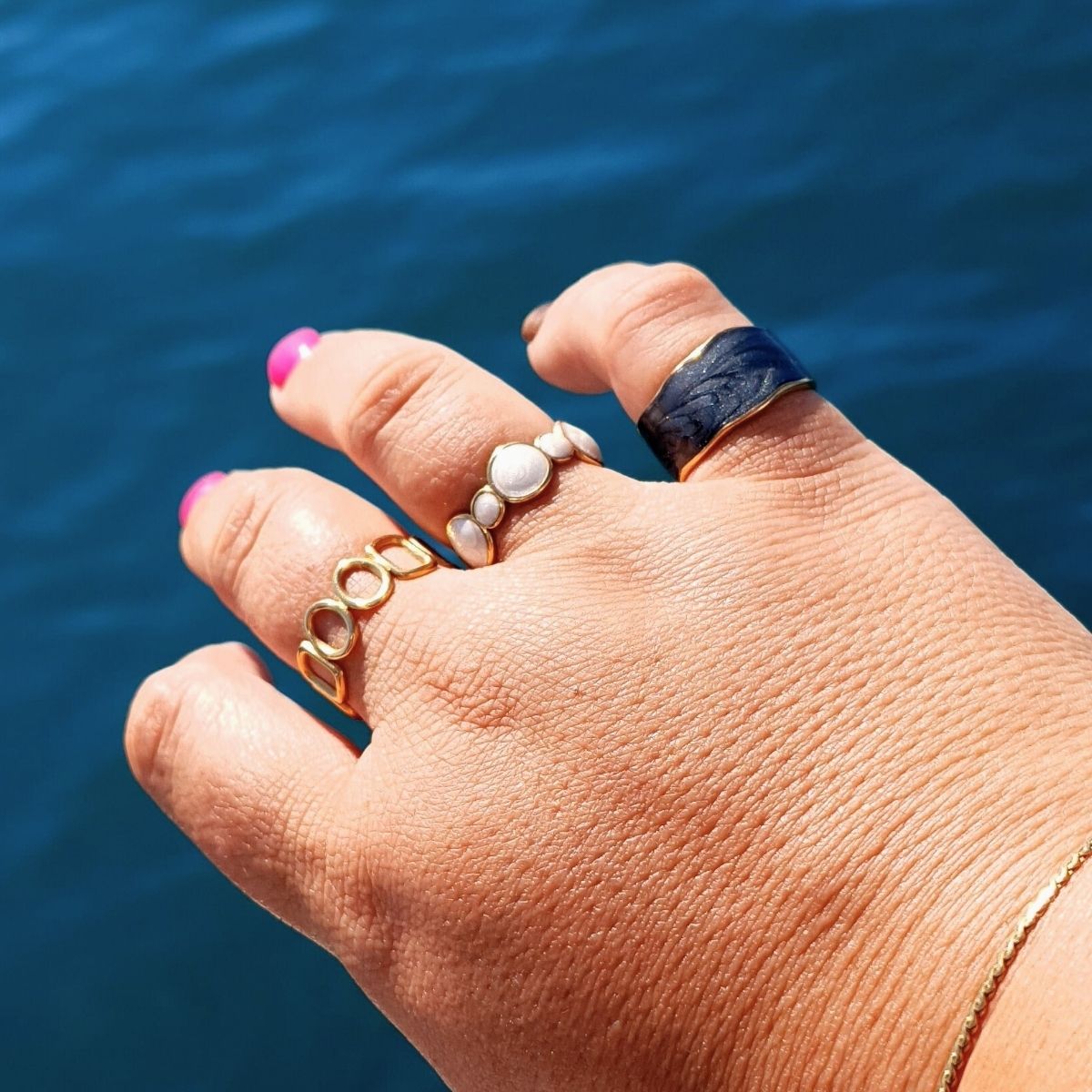 Close-up of a plus-size hand wearing three stylish 18K gold-plated rings, showcasing size-inclusive jewellery that fits and flatters every finger.