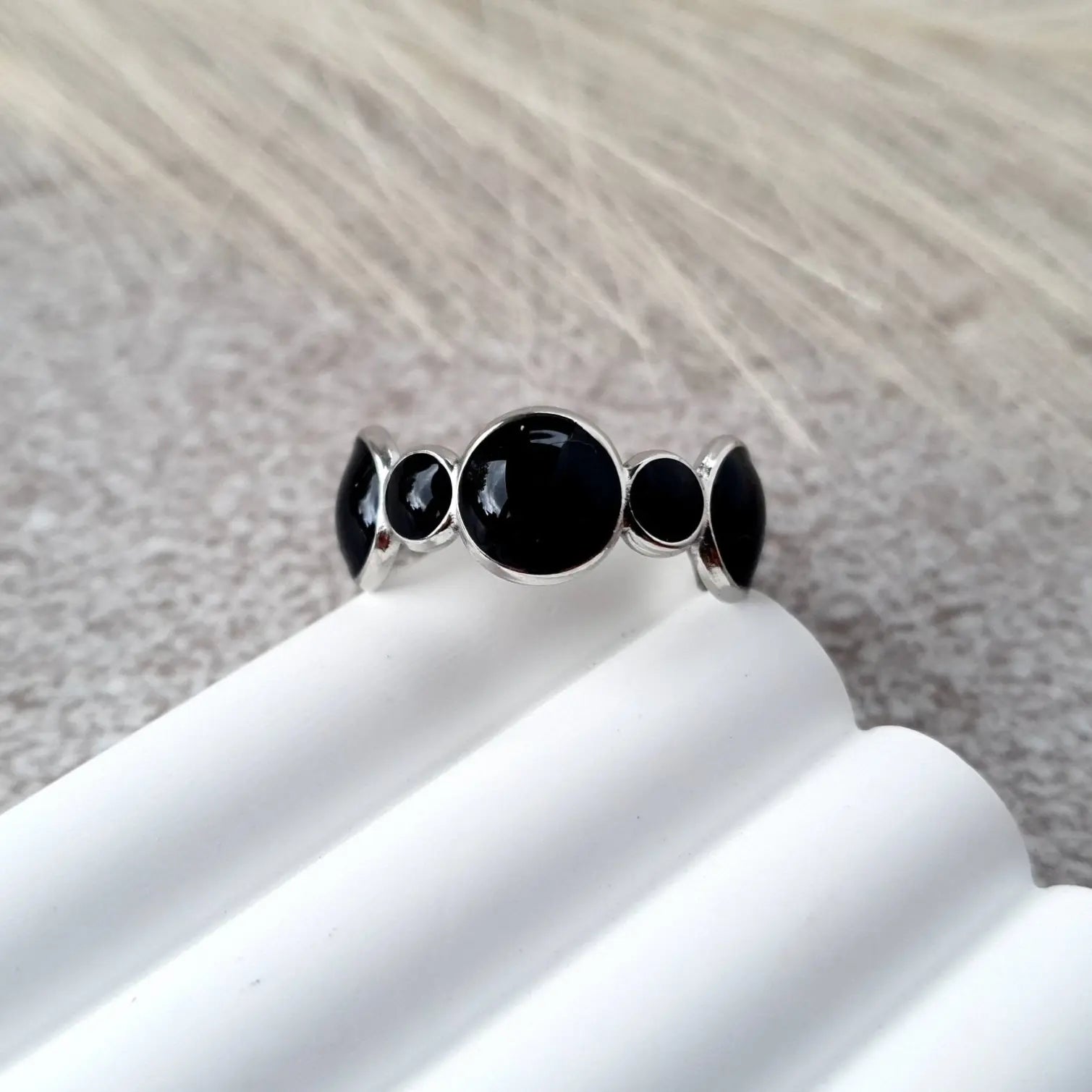 Bubbles adjustable ring in silver stainless steel with black oil dripping and rounded bubble-inspired design