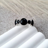 Bubbles adjustable ring in silver stainless steel with black oil dripping and rounded bubble-inspired design