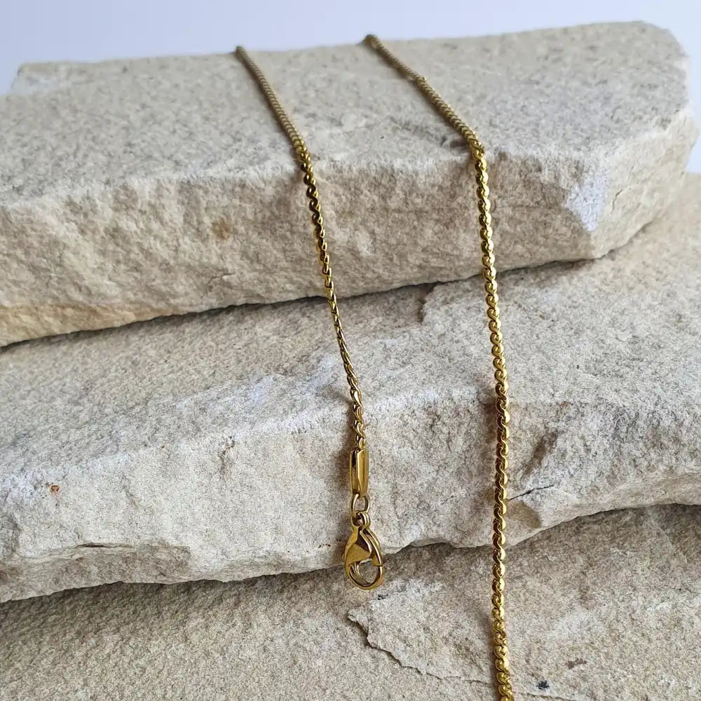 Gold twist chain jewelry set featuring adjustable necklace and bracelet with polished finish