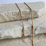 Gold twist chain jewelry set featuring adjustable necklace and bracelet with polished finish