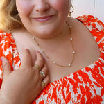 Plus-size woman wearing the 60cm Ocean Whispers Freshwater Pearl Necklace, featuring 18K gold-plated chain and natural freshwater pearls, adding elegance to any look.