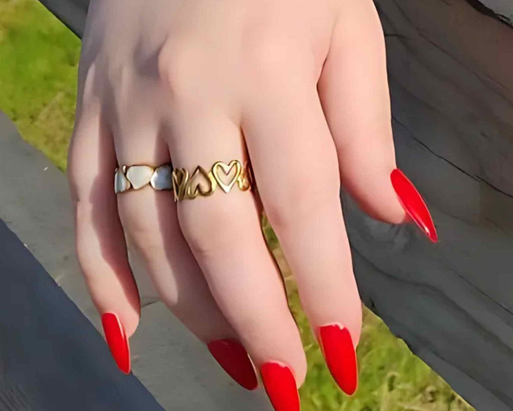 Woman wearing the Heart to Heart ring bundle with gold-plated Eternal Hearts and My Forever Love adjustable rings