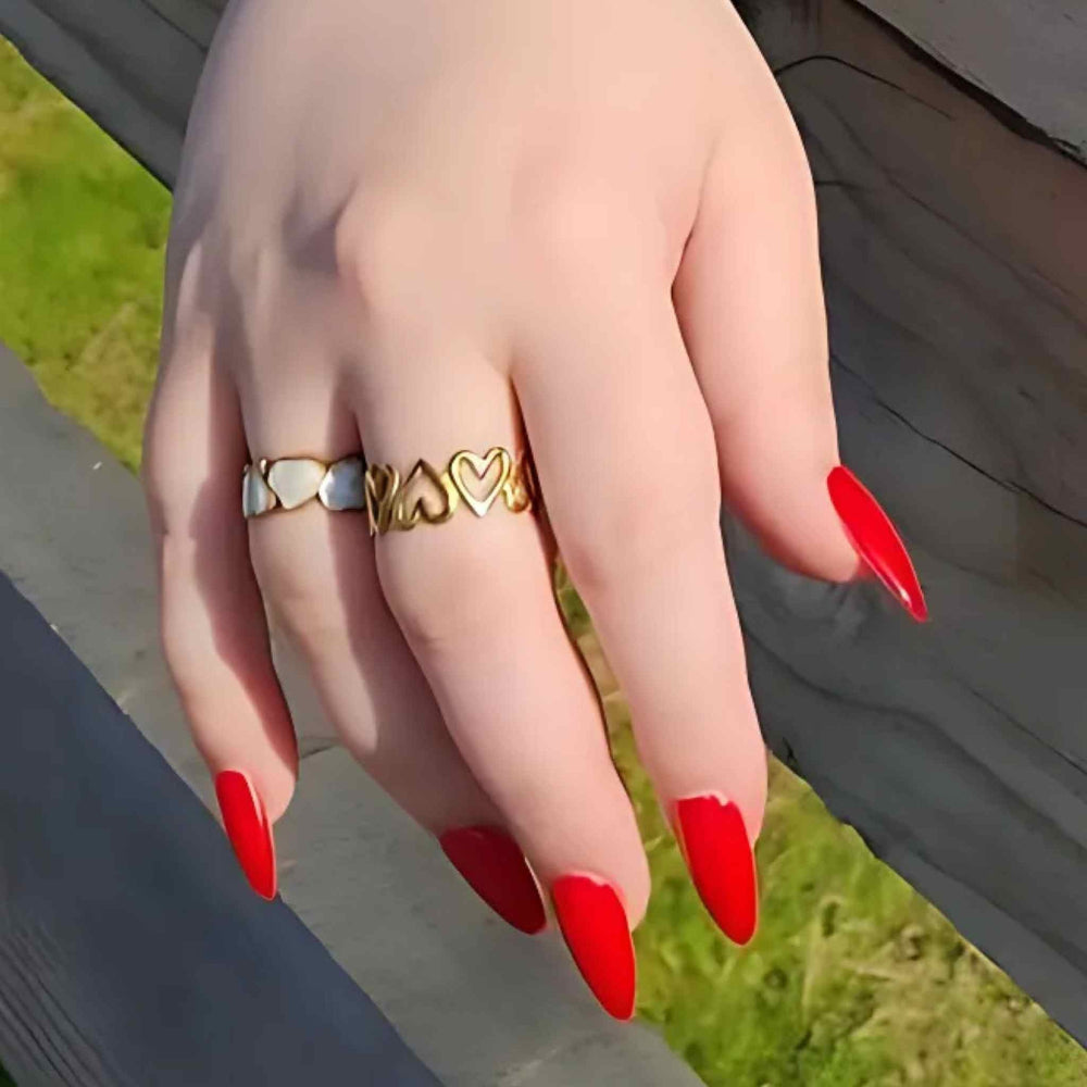 Woman wearing the Heart to Heart ring bundle with gold-plated Eternal Hearts and My Forever Love adjustable rings