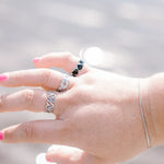 Silver ring stack on plu sized hand. My forever love, criss cross and eternal hearts adjsutable rings. All resizeable and size inclusive. 