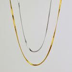 Sleek Snake Chain Necklace featuring both 18K gold-plated and classic silver options, with a stunning herringbone design. Available in 45cm+5cm and 60cm+5cm lengths. Waterproof, hypoallergenic, and tarnish-resistant.