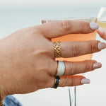 Plus-size woman’s hand styled with three 18k gold-plated rings, including the Timeless Elegance Open Ring, showcasing a layered, modern look with a minimalist gold finish.