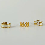 Three-piece gold ring bundle featuring 18K gold-plated adjustable rings with elegant white oil-dripping details, designed for bold, size-inclusive everyday wear.