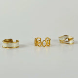 Three-piece gold ring bundle featuring 18K gold-plated adjustable rings with elegant white oil-dripping details, designed for bold, size-inclusive everyday wear.
